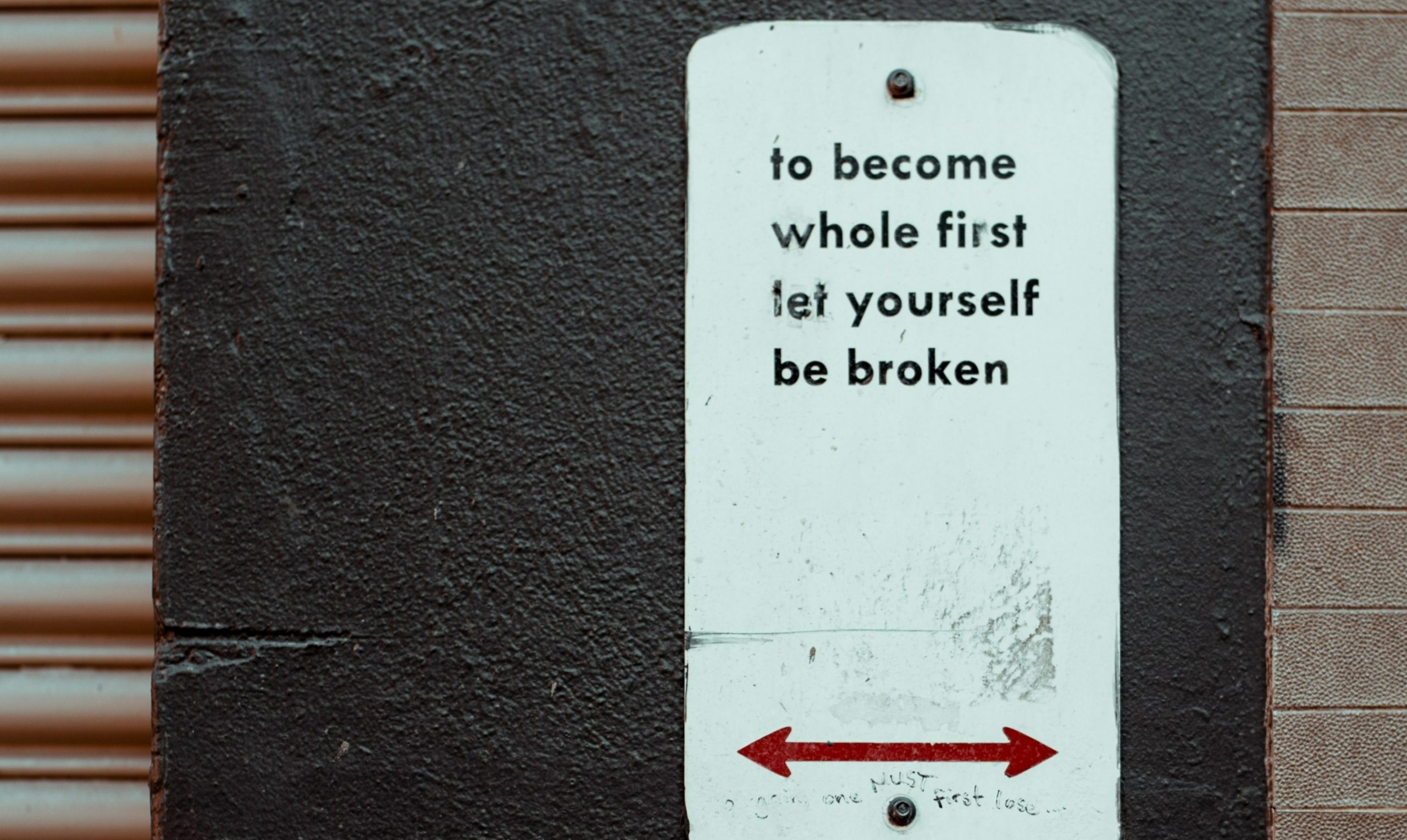 A sign that reads, to become whole first, let yourself be broken